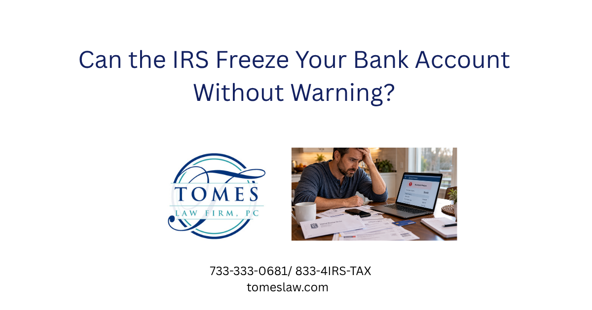 Worried taxpayer reviewing a frozen bank account on his laptop with an IRS notice and unpaid bills on the table.